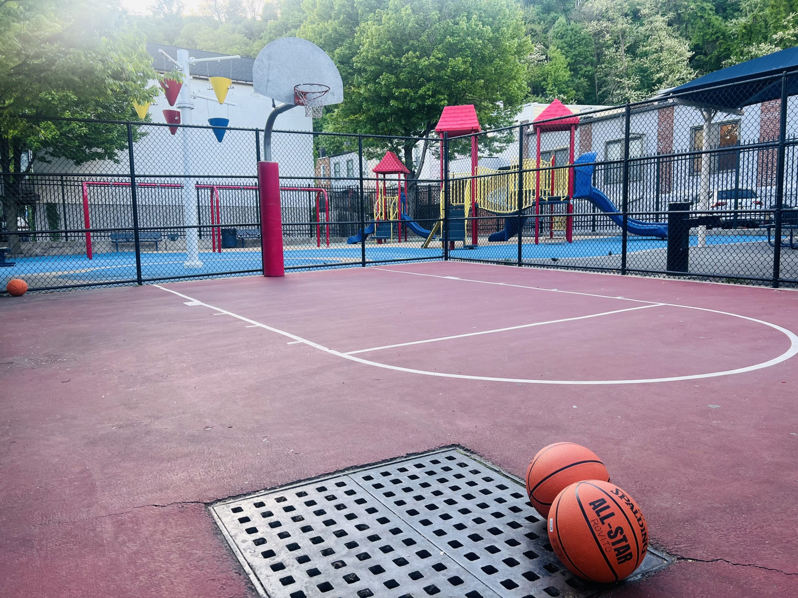 Basketball court with playground beyond