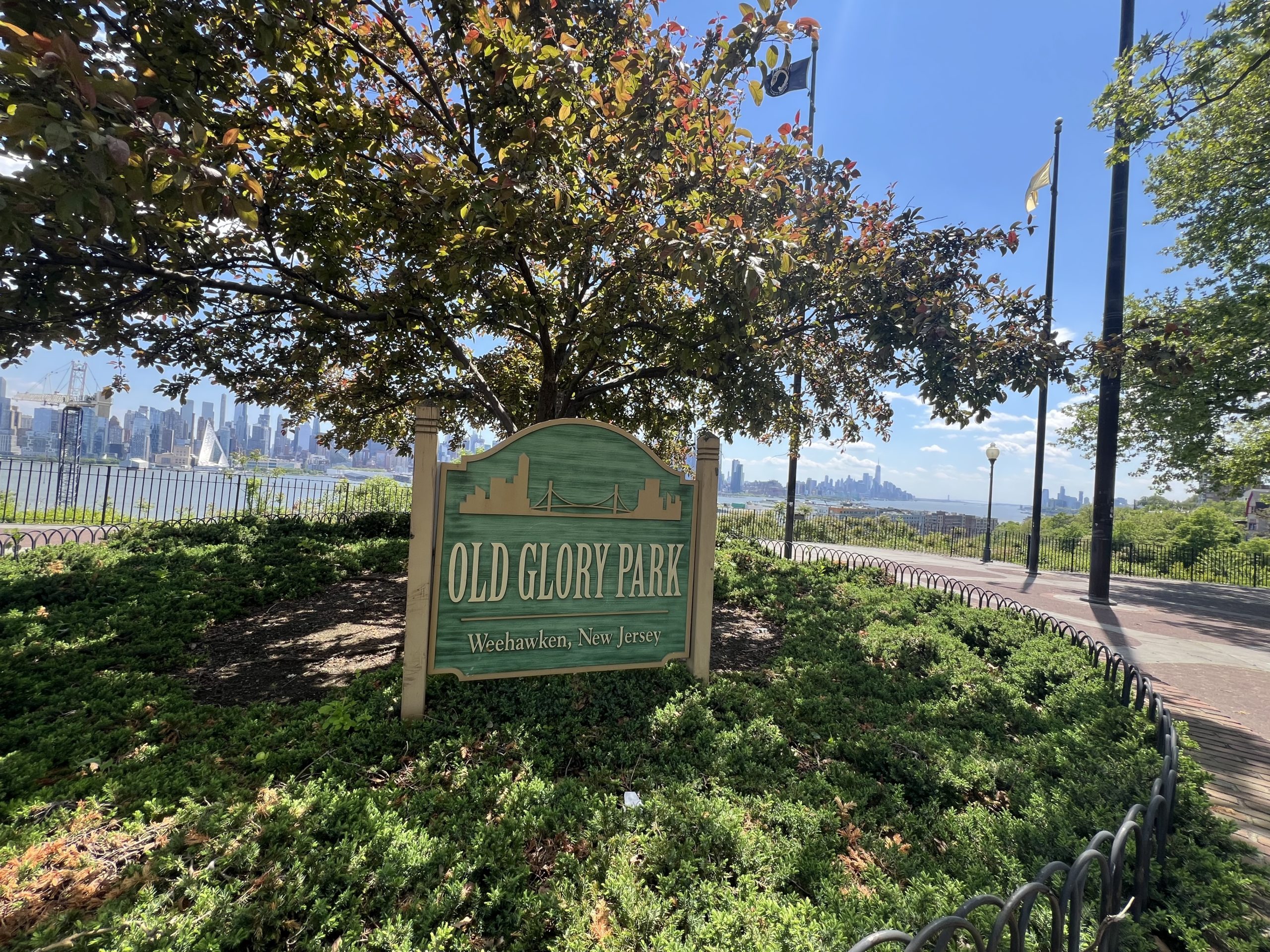 Old Glory Park sign with Manhattan skyline in background