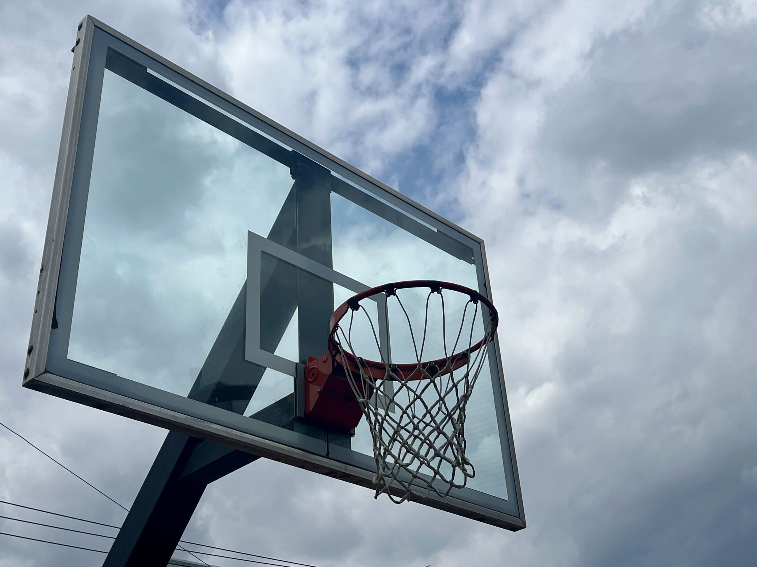 cloudy sky and basketball hoop